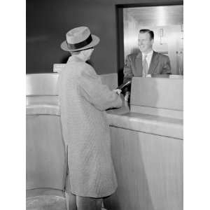  Man Talking To Teller in Bank, Vault in Background 
