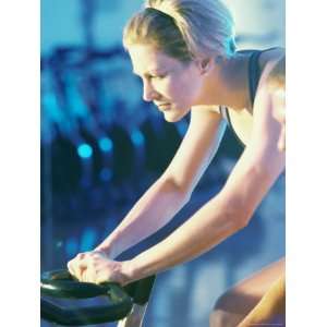 Side Profile of a Young Woman Exercising on a Cycling Machine Giclee 