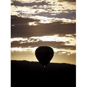 The Silhouette of a Hot Air Balloon and Jet Flame at Dawn, Australia 