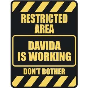   RESTRICTED AREA DAVIDA IS WORKING  PARKING SIGN