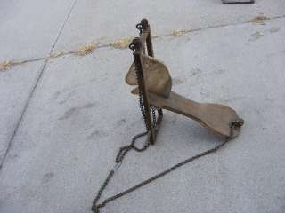 Antique kids riding toy horse made of wood with chains for a swing or 