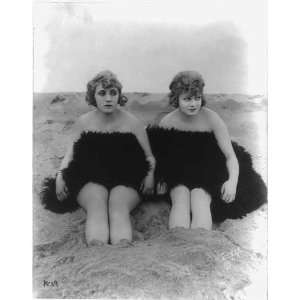   on beach,draped in a fur,with feet in sand,c1918