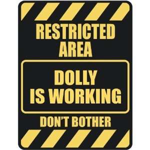   RESTRICTED AREA DOLLY IS WORKING  PARKING SIGN