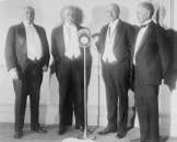 early 1900s photo Standing at microphone, left to  