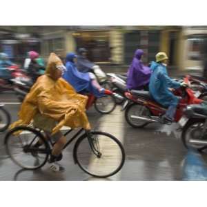  People Riding Bikes and Mopeds in the Rain Wearing Nylon 