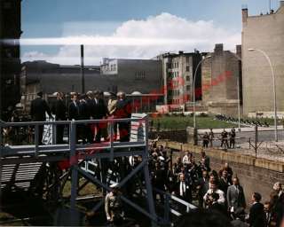  John F. Kennedy mounts a platform overlooking the Berlin Wall 